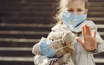 serious-girl-in-protective-mask-holding-plush-toy-in-mask-4000605